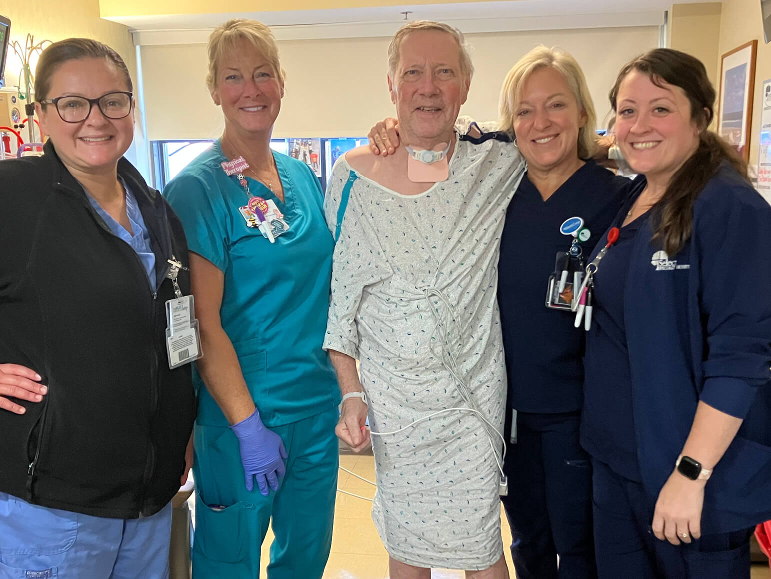 Paul Hettinger stands with his care team.